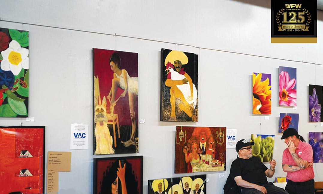 Navy veteran Jimmy Martinez, left, speaks with VFWPost 1member and fellow artist Brian Asbeck during First Friday ArtWalk at Post 1 on May 2 in Denver