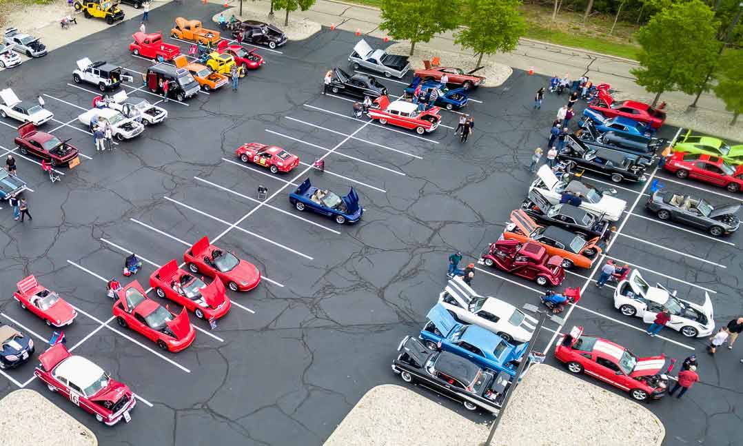 Enthusiasts browse exotic and vintage cars during VFW Post 10338’s ninth annual “Cars and Courage” car show