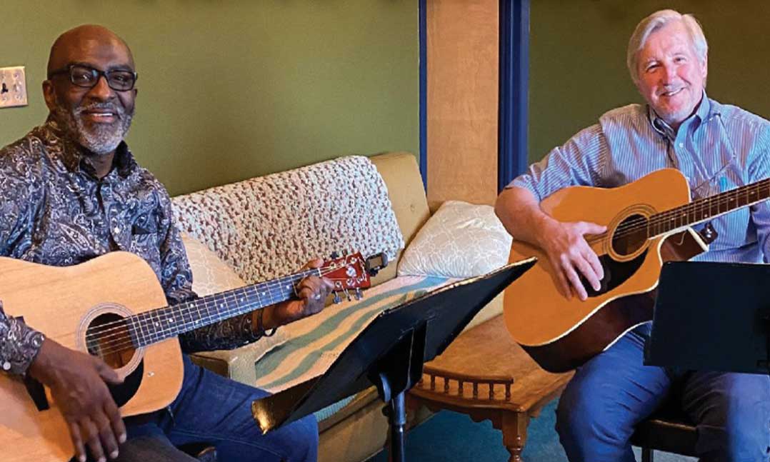 Two men playing guitar
