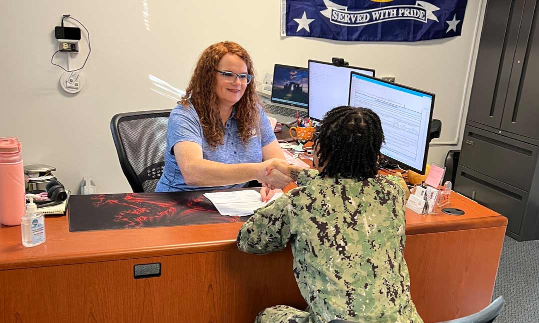 VFW National Pre-Discharge Claims Representative Abigail Heffernan greets a sailor at Naval Station Norfolk VA