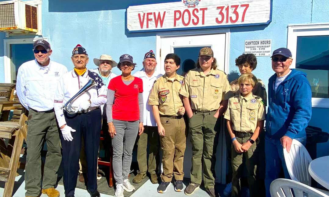 Post members stand with Boy Scouts for flag disposal