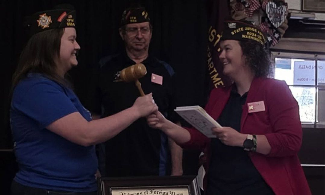 Holly Pierce, right, swears in her sister, Julia, as VFW District Commander in May