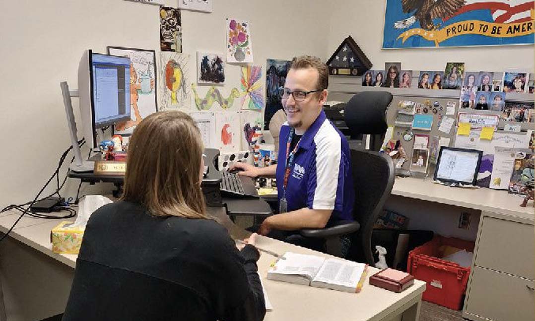 VFW Service Officer Jeffrey Cowell helps a fellow veteran with her VA claim