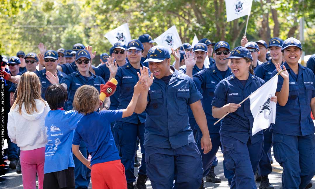 Coast Guardsmen celebrate walking in a July 4 parade